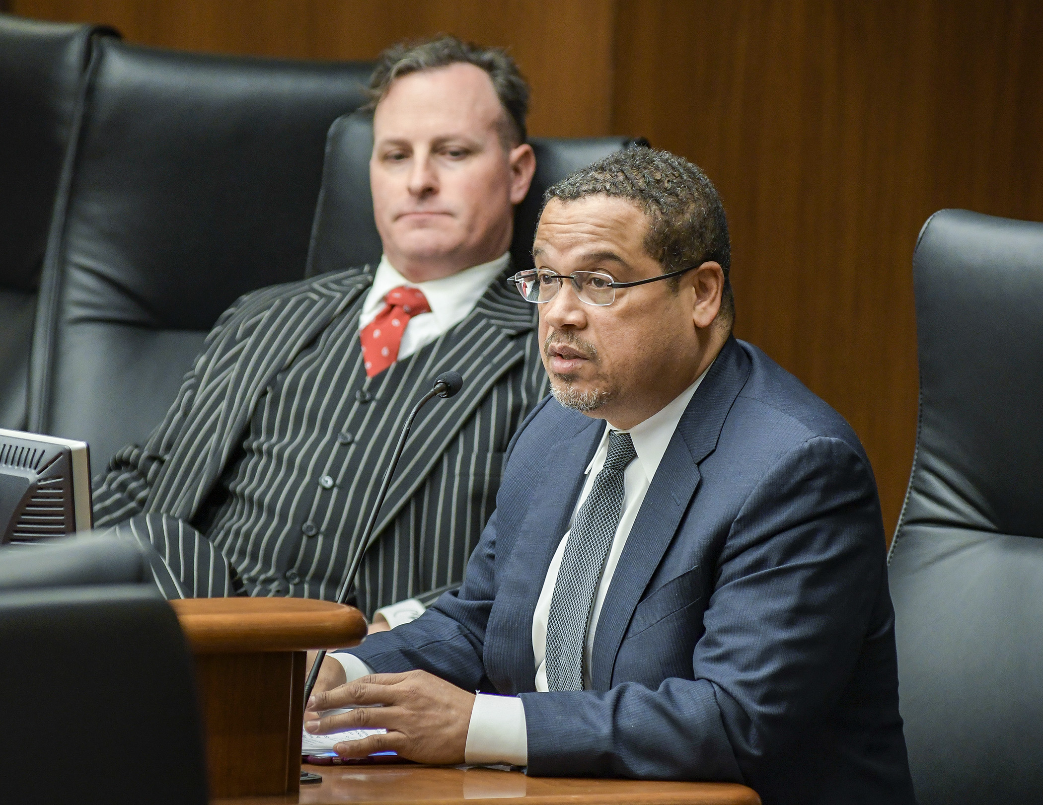 Attorney General Keith Ellison testifies before the House Health and Human Services Policy Committee Feb. 5 in support of a bill sponsored by Rep. John Lesch, left, to prohibit prescription drug price gouging. Photo by Andrew VonBank